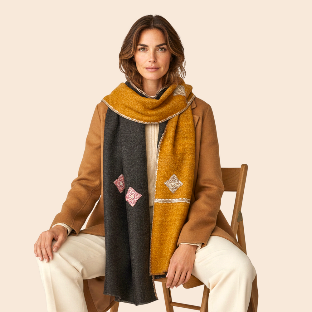 Indus Weavers reversible dark brown and mustard Pashmina shawl with intricate Aksi embroidery worn by a woman.