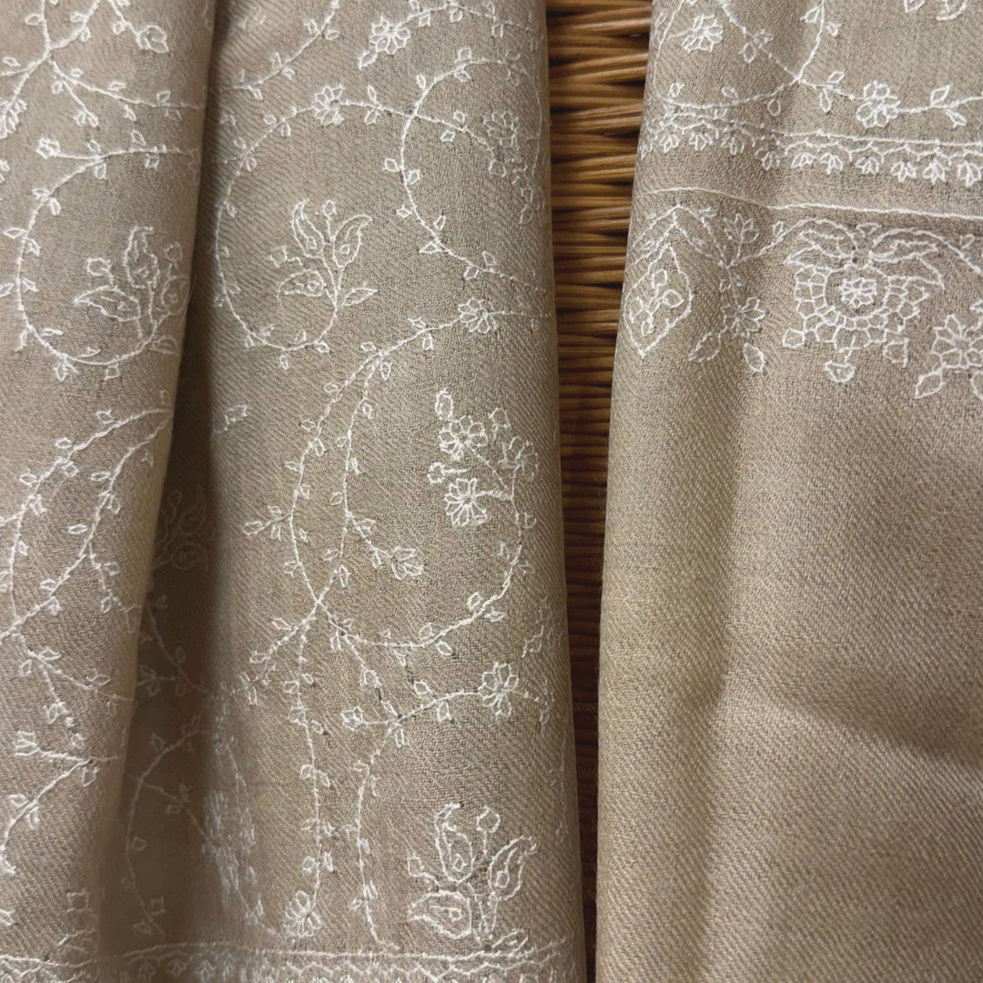 Beige Pashmina with white floral embroidery, draped on maniquine