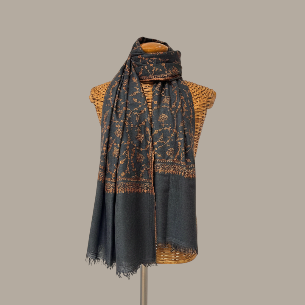 Indus Weavers charcoal pashmina shawl featuring intricate copper floral Sozni embroidery and hand-finished fringes.