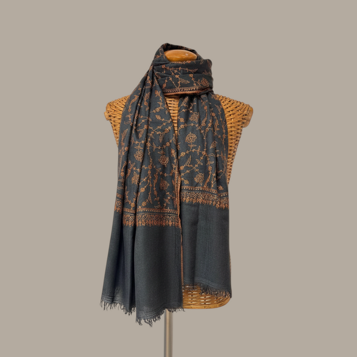 Indus Weavers charcoal pashmina shawl featuring intricate copper floral Sozni embroidery and hand-finished fringes.
