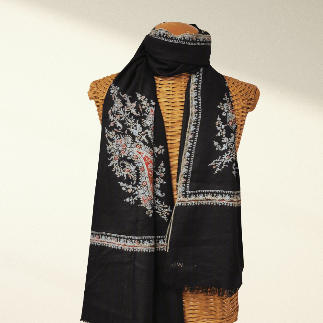 Black embroidered pashmina scarf draped over a mannequin with a beige background