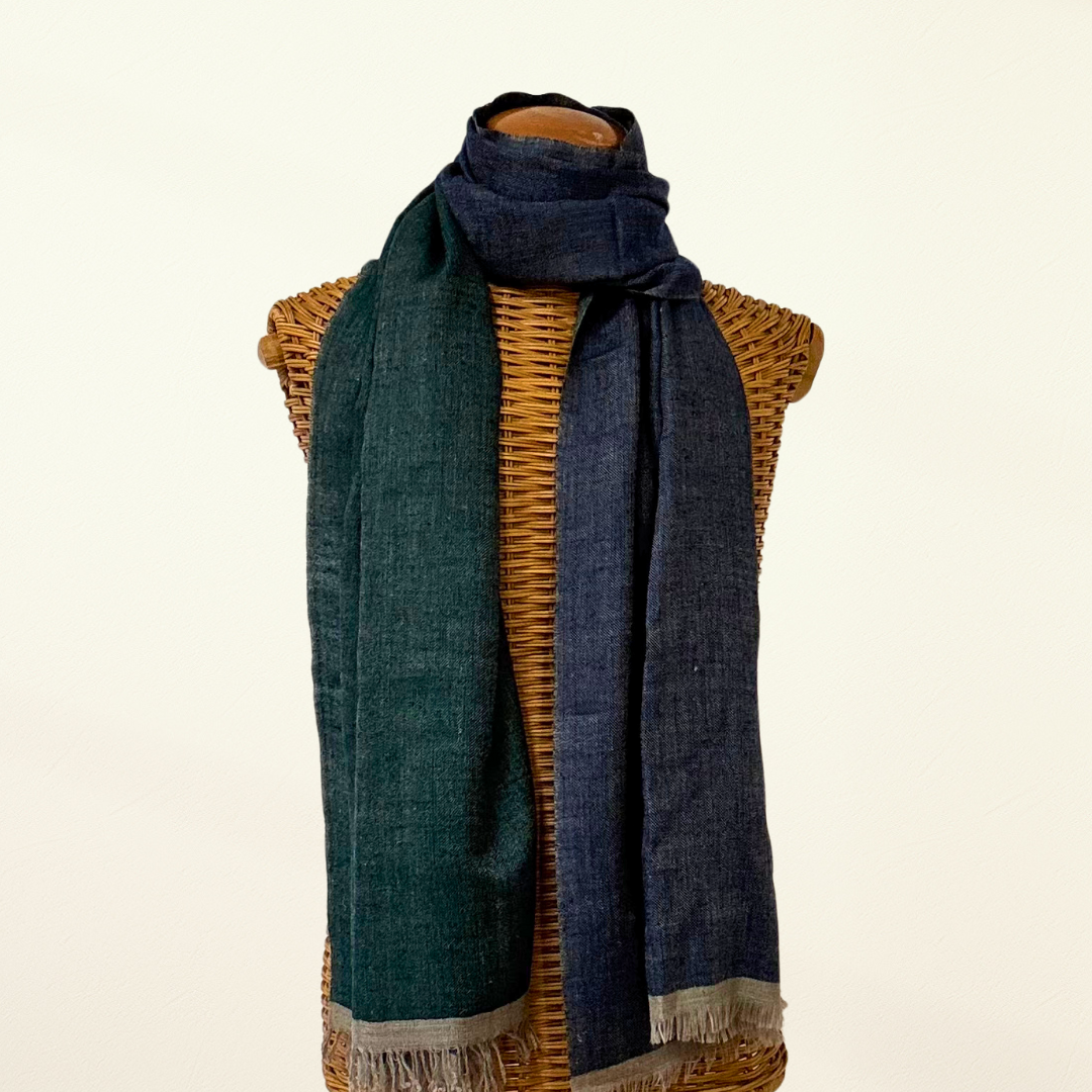 Blue and green pashmina scarf draped over a wicker mannequin on a beige background