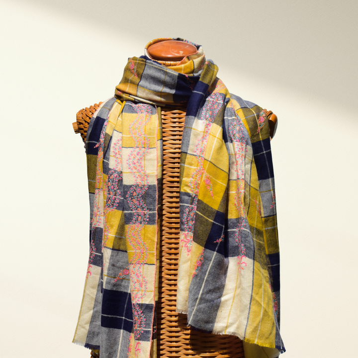 Checkered Pashmina shawl with a patchwork pattern draped over a mannequin on a white background
