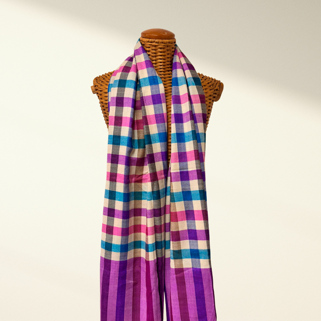 Colorful checkered pashmina scarf on a mannequin against a plain background