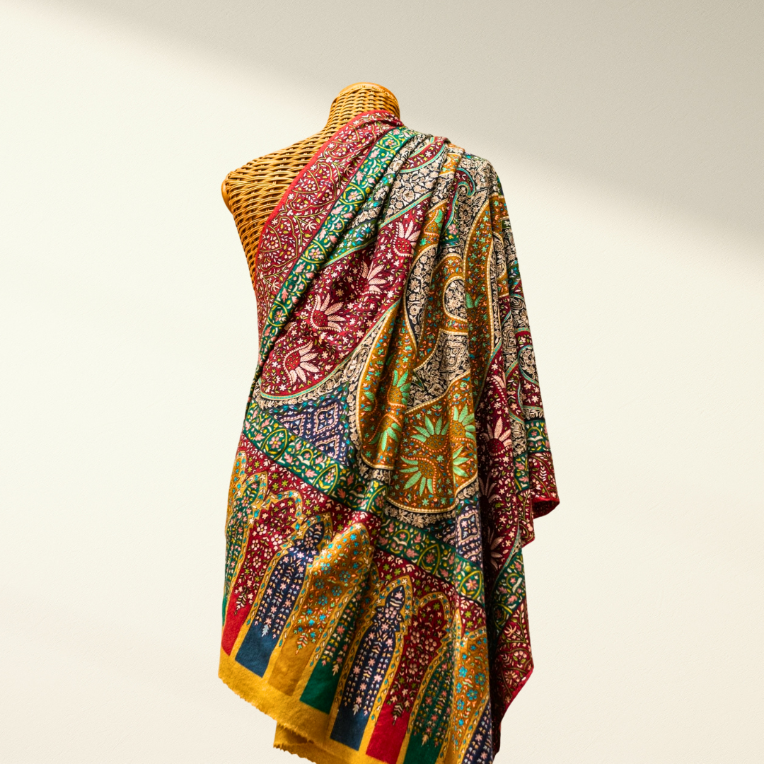 Colorful jamawar wedding pashmina shawl draped over a mannequin on a plain background