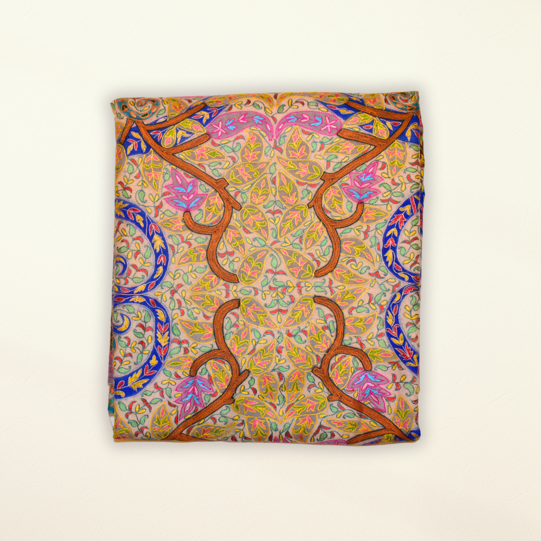 Colorful patterned pashmina shawl with intricate design on a beige background
