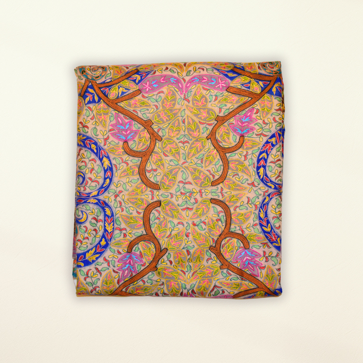 Colorful patterned pashmina shawl with intricate design on a beige background