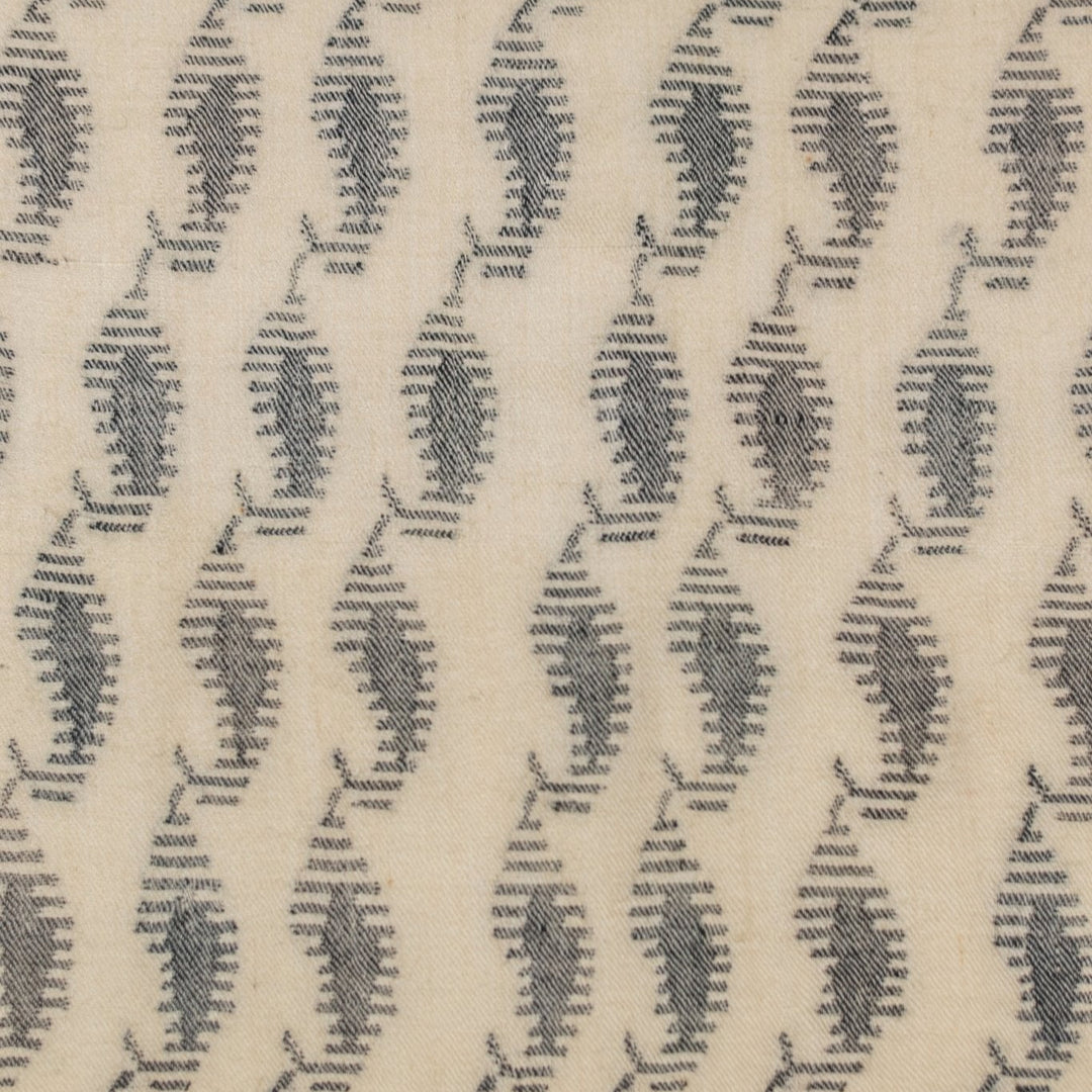 Handwoven cashmere scarf featuring classic black and white paisley design.
