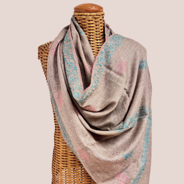 Gray Pashmina scarf Bliss with floral patterns draped over a mannequin on a beige background