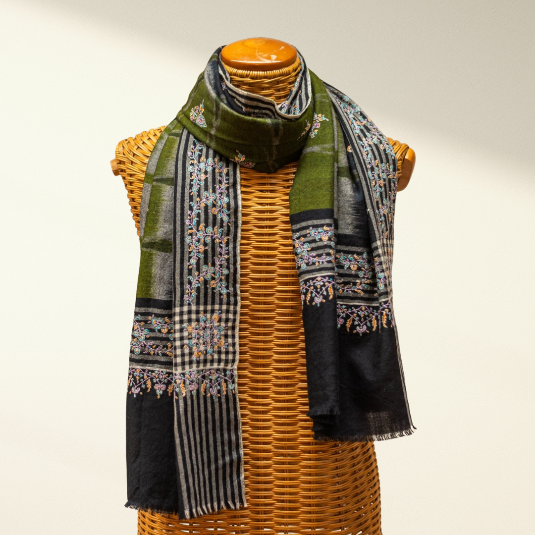 Green and black patterned pashmina scarf on a mannequin with a white background