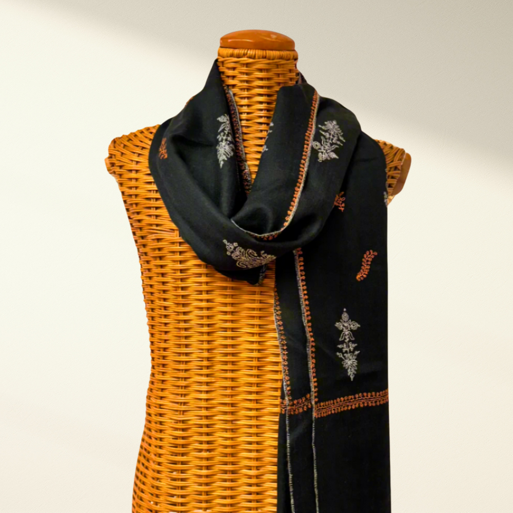 Green pashmina scarf with floral embroidery on a mannequin 