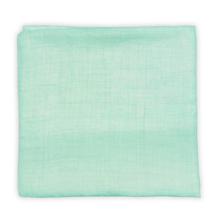 Light green pashmina flatlay on a white background