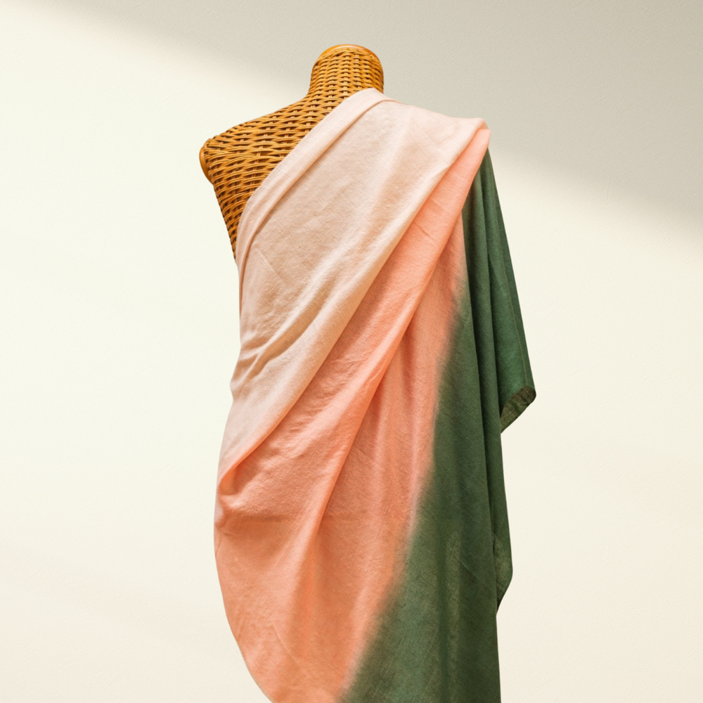 Mannequin draped with peach and green ombre pashmina against a neutral background
