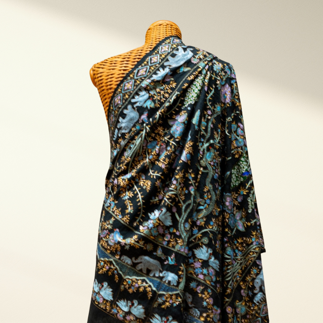 Mannequin wearing a floral patterned pashmina shawl with a neutral background