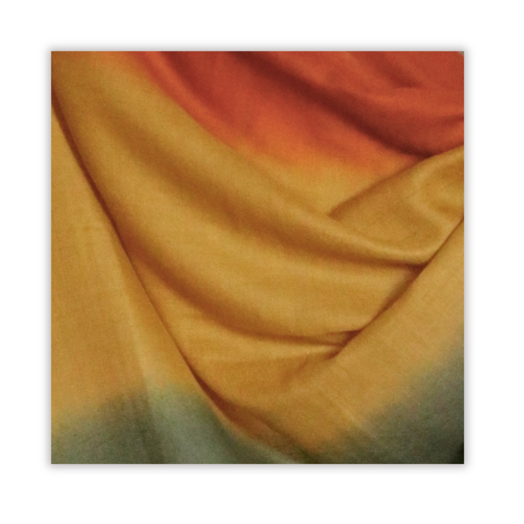 ombre pashmina swatch transitioning from  orange to yellow to green on a white background