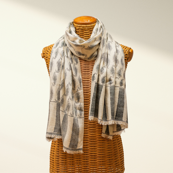 Kashmiri Pashmina Shawl with black and white pattern draped over a wicker mannequin on a plain background