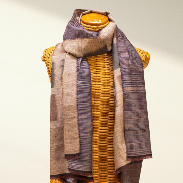 pashmina scarf amber draped over a wicker basket on a neutral background