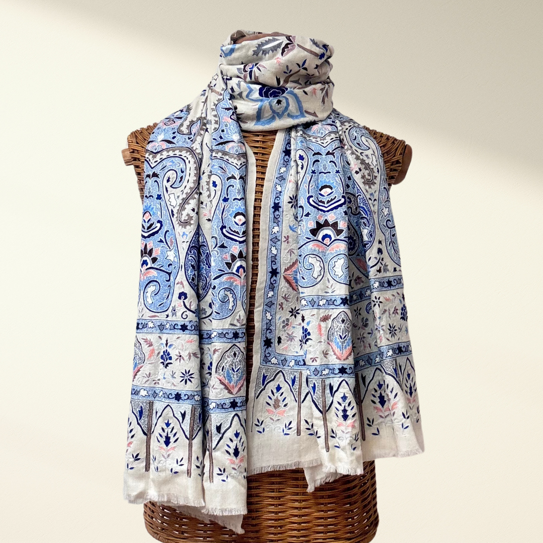 Pashmina Shawl Boteh with blue and pink embroidery draped over a wicker mannequin on a beige background