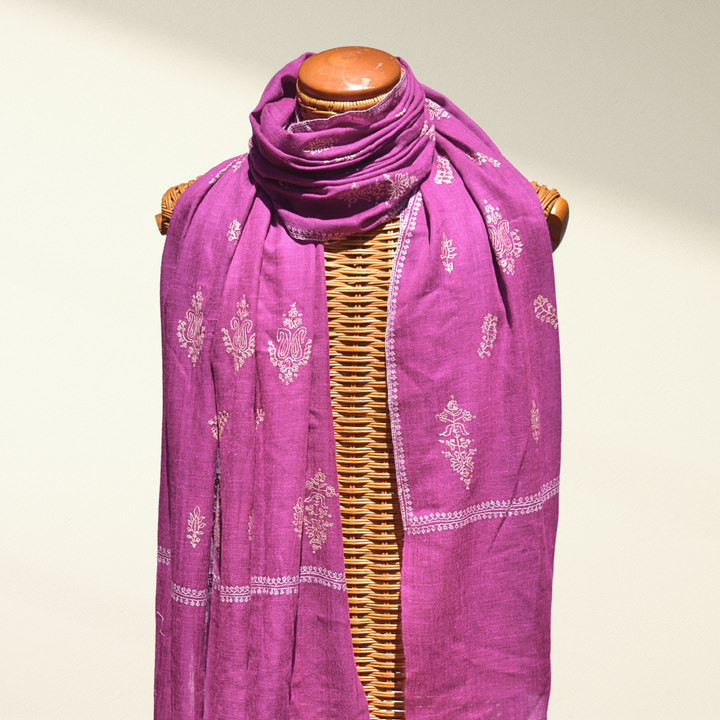 Pink Pashmina Scarf with white patterns on a wooden mannequin against a neutral background