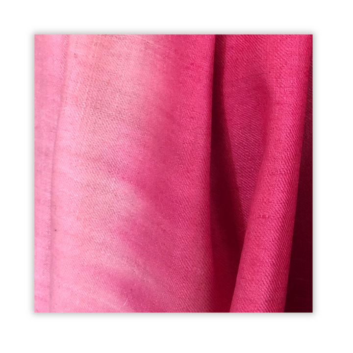 Close-up of pink fabric texture on a white background