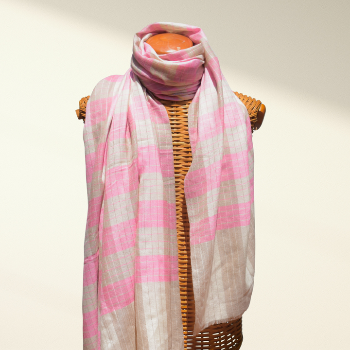 Pink and beige checkered pashmina scarf on a mannequin against a plain background