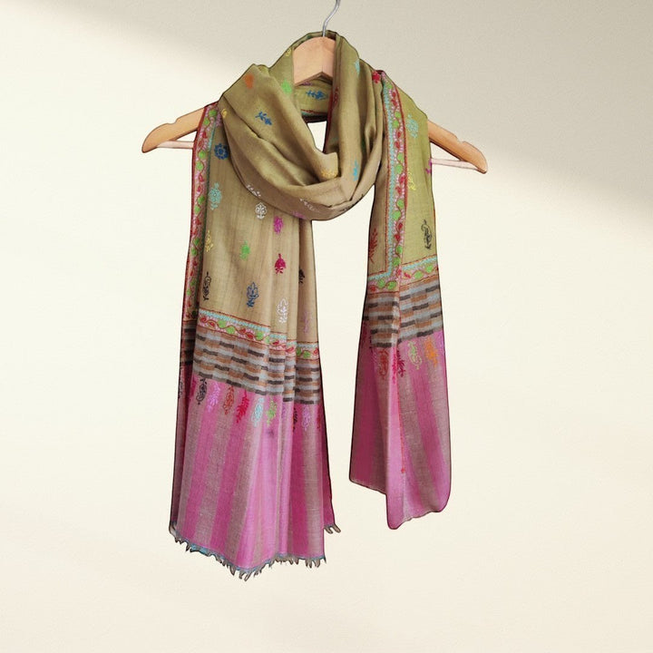 Blust olive Colorful scarf with intricate patterns on a hanger against a light background