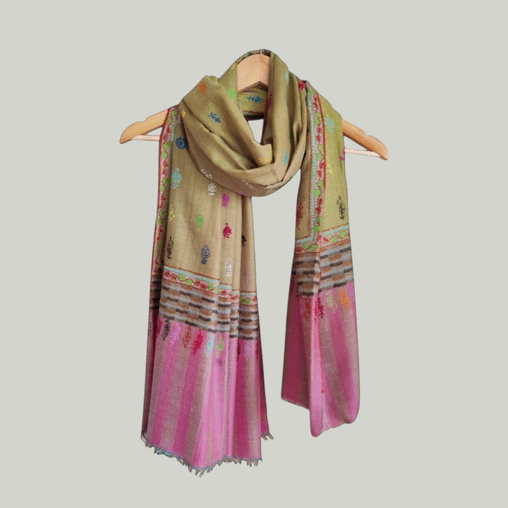 Blust olive Colorful scarf with intricate patterns on a hanger against a light background