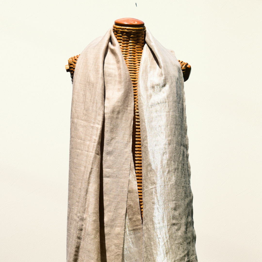 Mannequin wearing a reversible beige pashmina shawl on white background