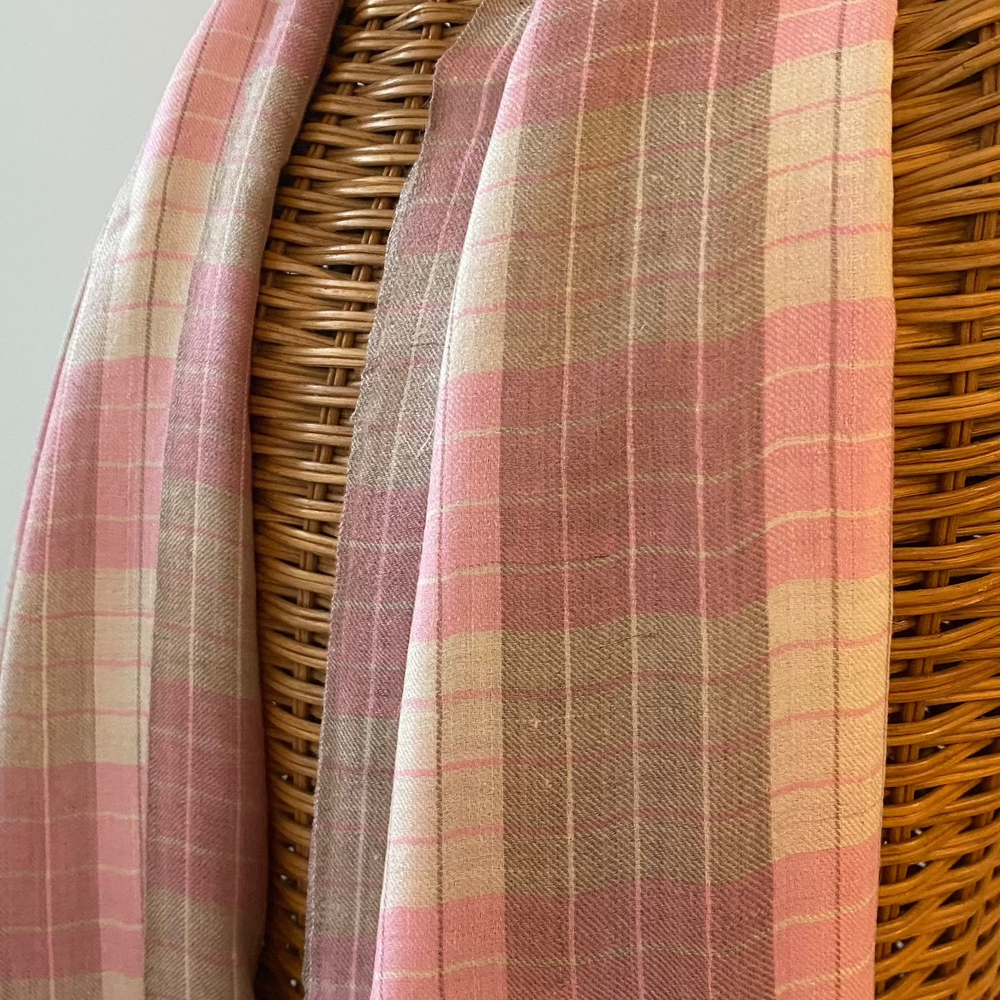 Reversible pink and white Pashmina shawl with modern checkered design draped on mannequin