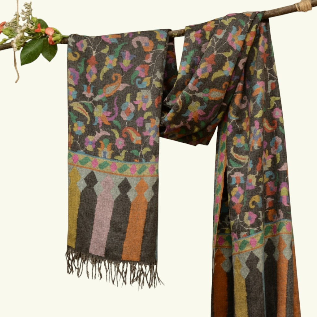 KARINA Pure Kashmiri Kani Pashmina Shawl – Lifestyle Shot Draped on Branch Highlighting Greyish Black Kani Weave & Fringe Detail | Indus Weavers