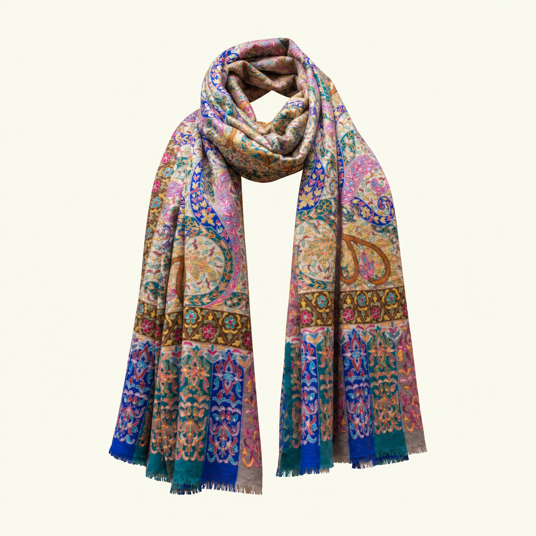 A multicolor paisley and ornamental pattern pashmina kalamkari scarf draped in a loop, featuring intricate designs in pink, blue, gold, and green on a cream background, set against a solid off-white backdrop.