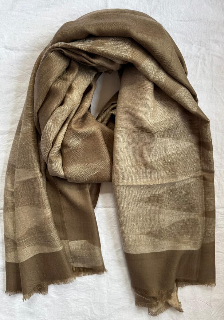Brown scarf draped over a white surface