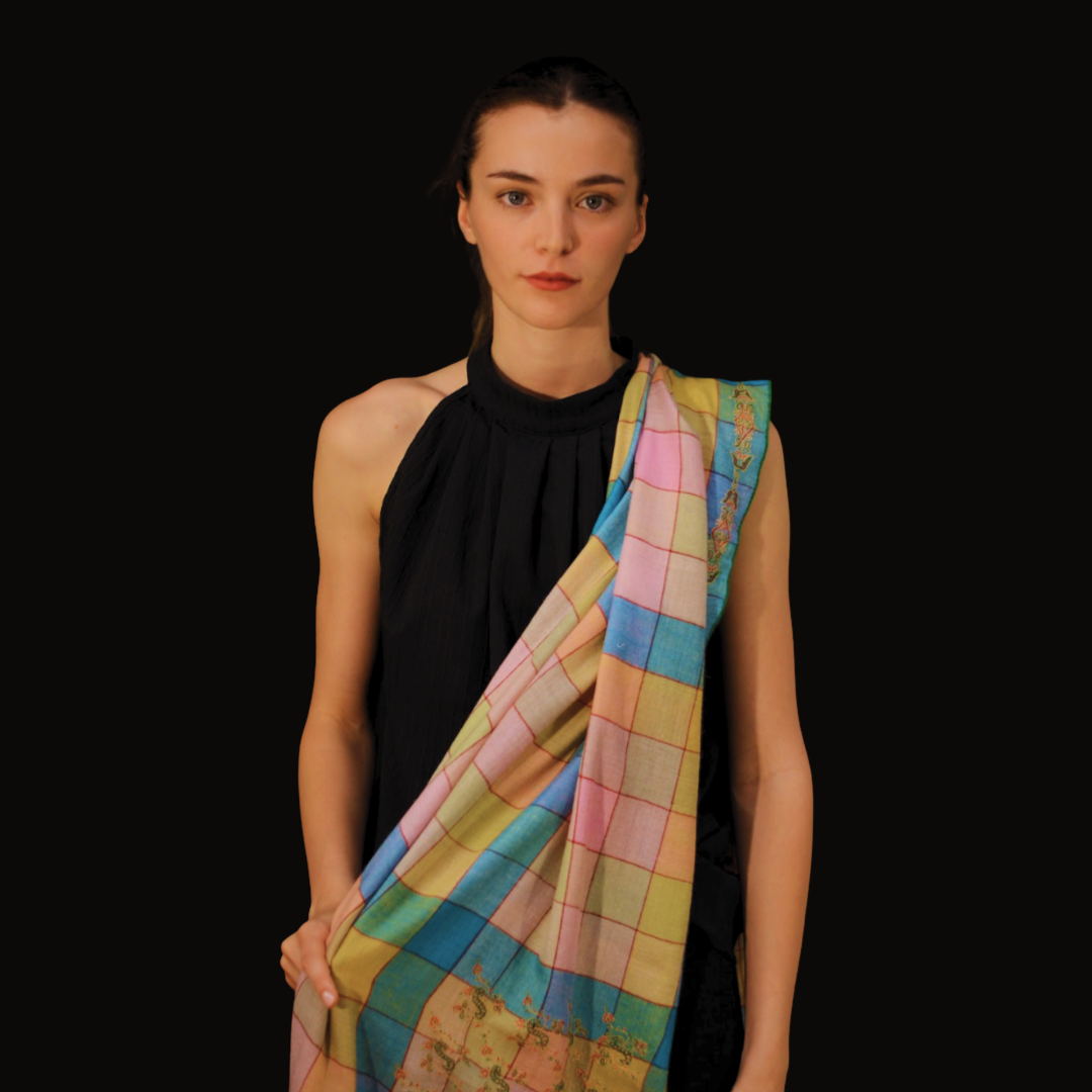 Woman wearing a colorful checkered pashmina scarf on a black background