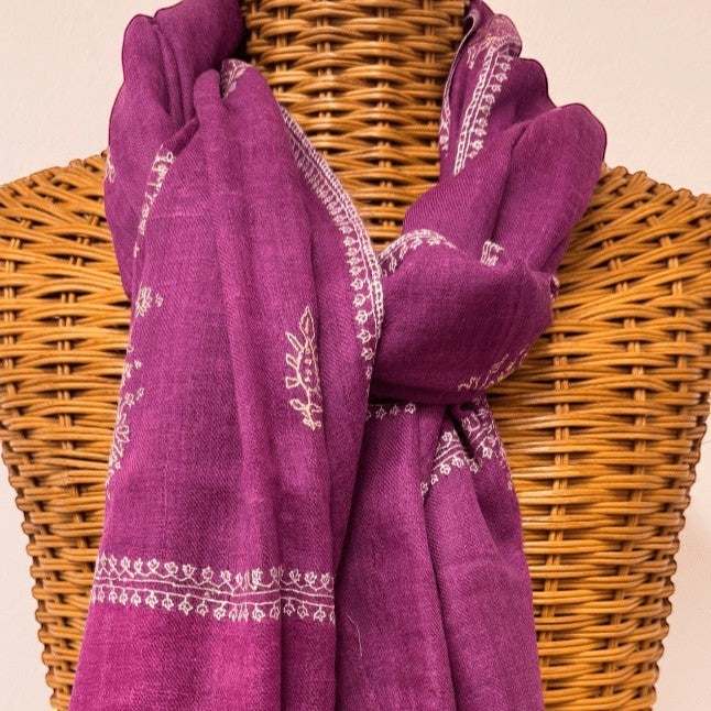 Indus Weavers dark pink handwoven 100% cashmere Pashmina shawl with intricate white hand embroidery along the edges and scattered motifs.