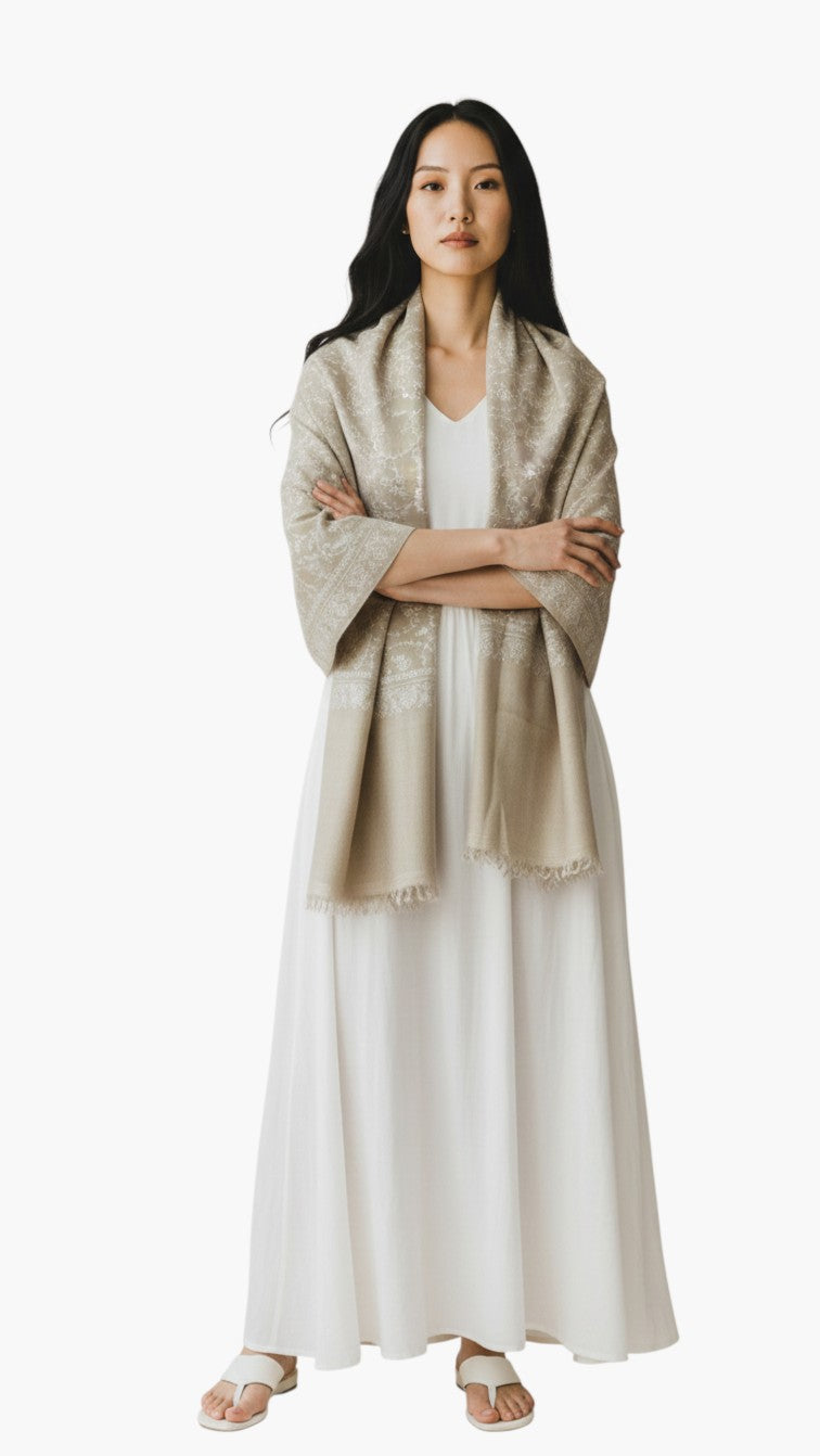 Indus Weavers ELARA taupe pashmina shawl with white Sozni floral embroidery draped over a woman in a white dress