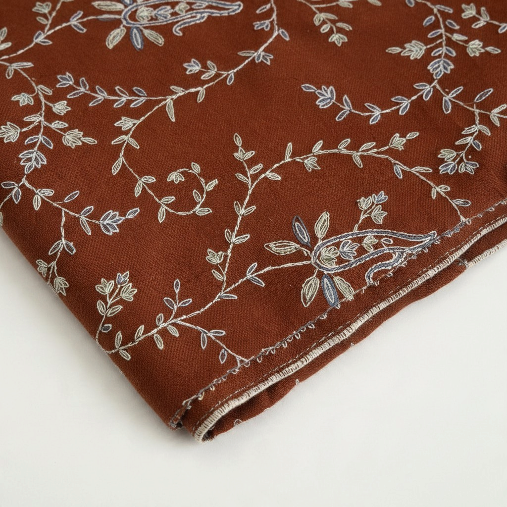 Indus Weavers TERRA pashmina shawl in brown with ivory, blue, and sage floral Sozni embroidery in a Jaal pattern.