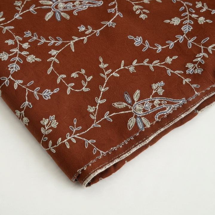 Indus Weavers TERRA pashmina shawl in brown with ivory, blue, and sage floral Sozni embroidery in a Jaal pattern.