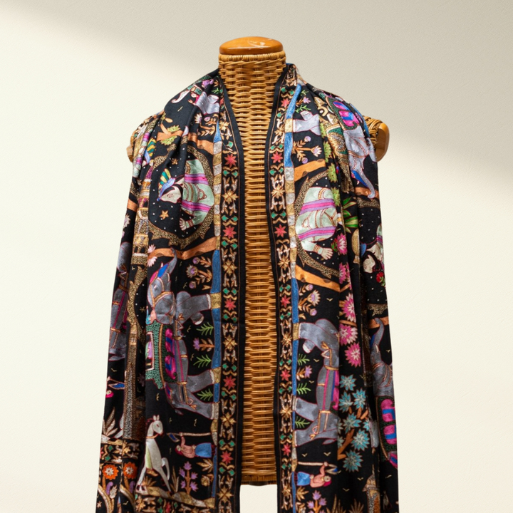 Mannequin wearing a Jamawar pashmina shawl on a plain background