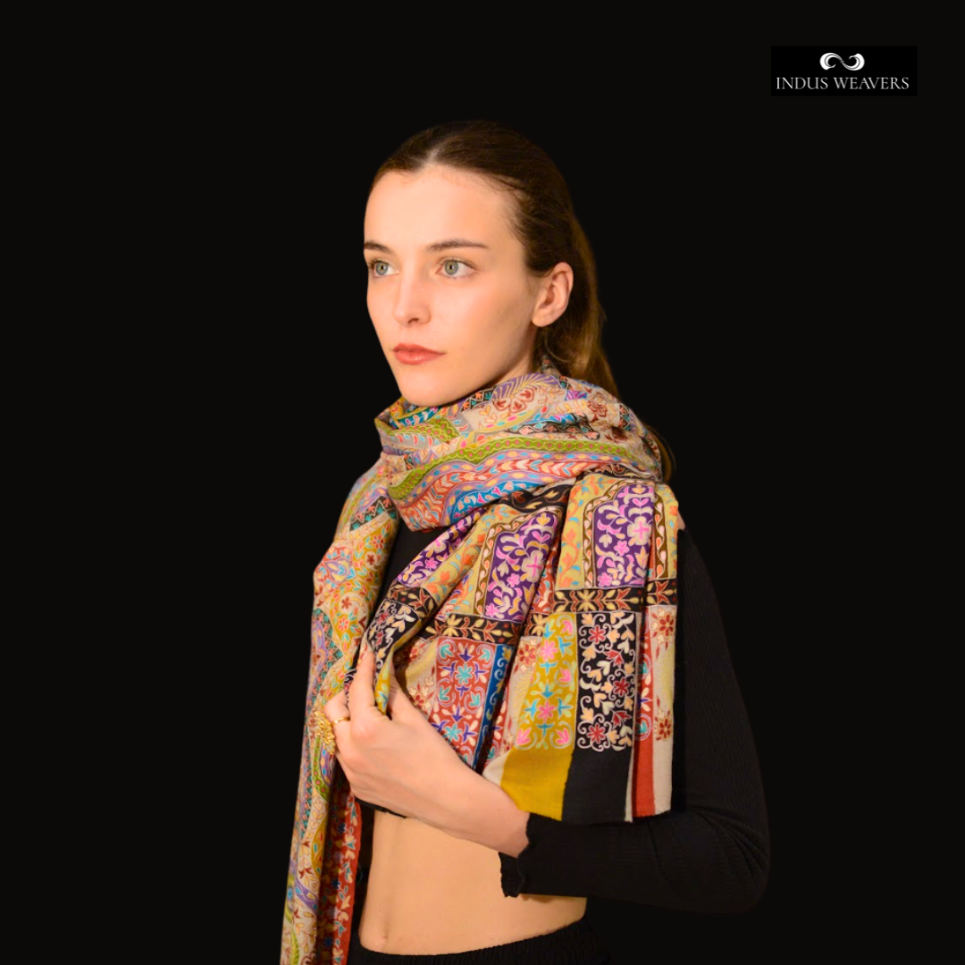 Woman wearing a kalamkari pashmina shawl with 'Indus Weavers' branding in the corner.