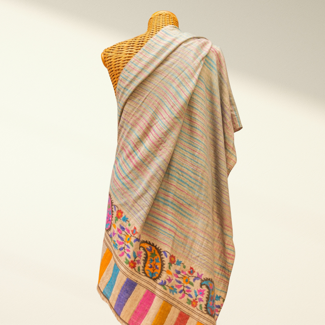 kani pashmina shawl on a mannequin against a plain background