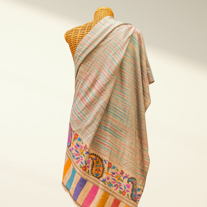 kani pashmina shawl on a mannequin against a plain background