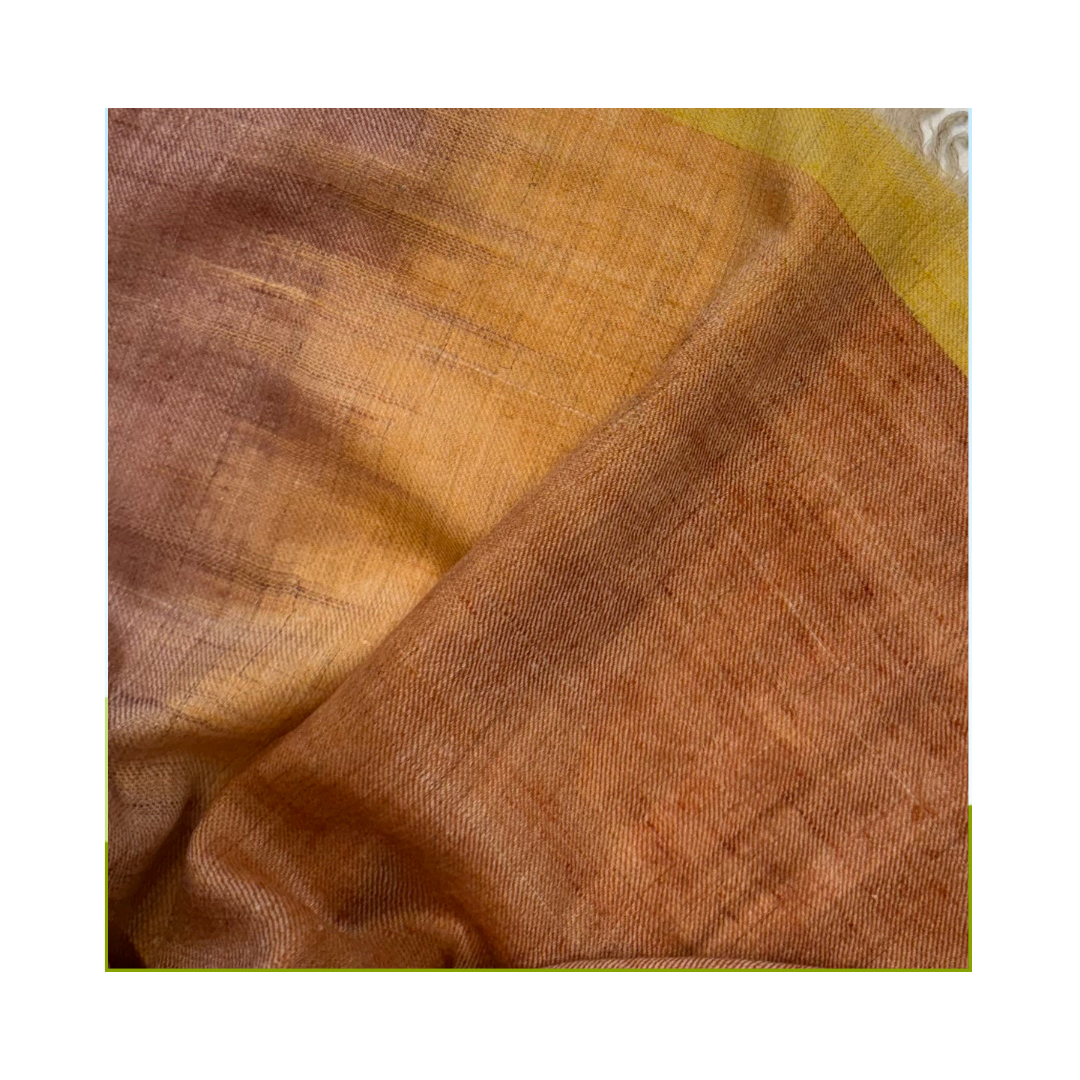 A Close-up of a handwoven Pashmina shawl in muted dusty mauve, warm taupe and soft ochre tones, featuring delicate Ikat-inspired colour transitions and a finely textured artisanal weave.