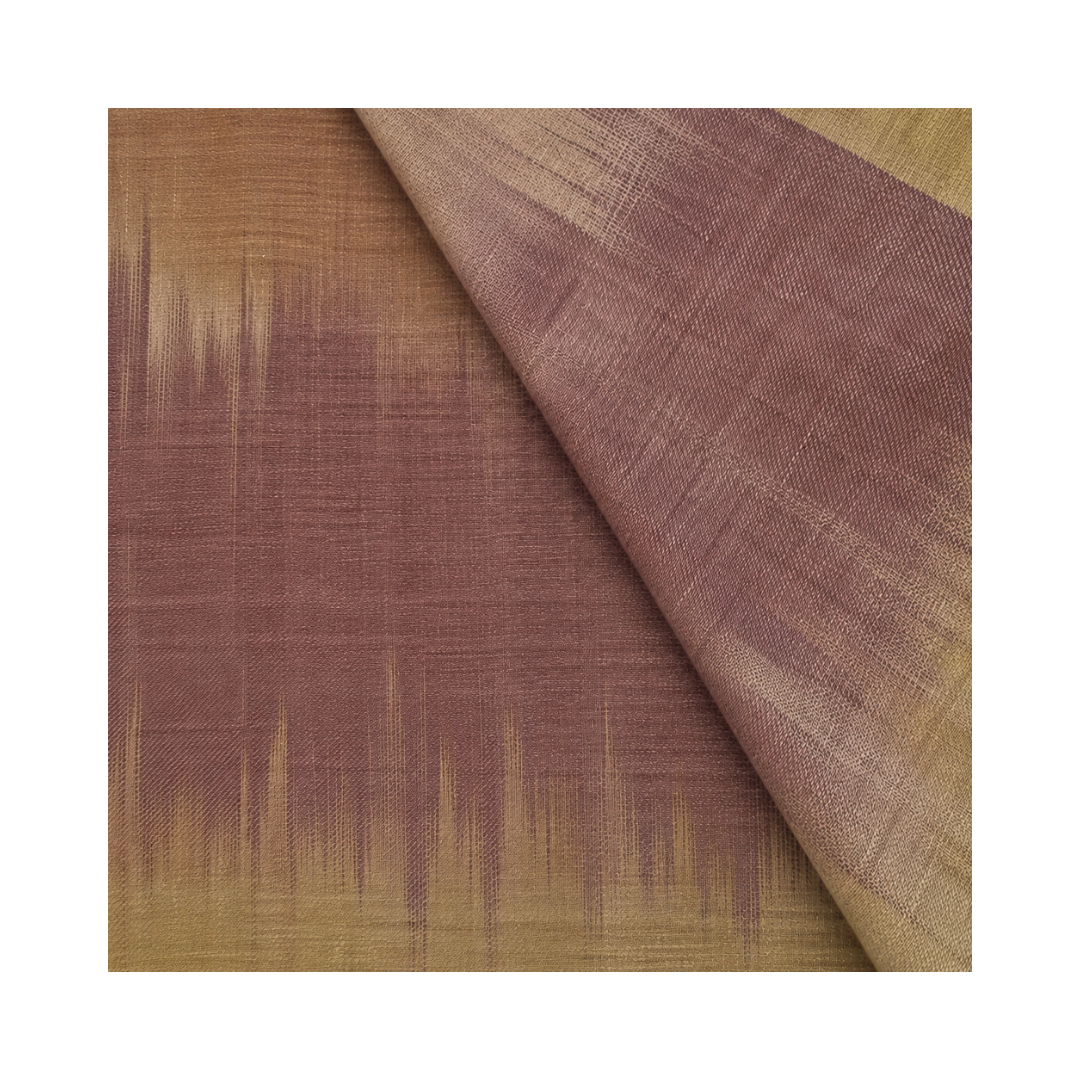 A close-up of a pashmina fabric sample with a warm brown and dusty mauve ikat-like pattern, shown with one corner folded over on a white background.