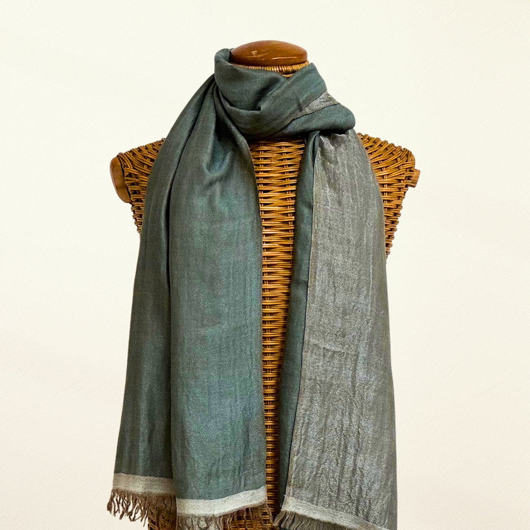 reversible scarf draped over a wicker mannequin with a plain background