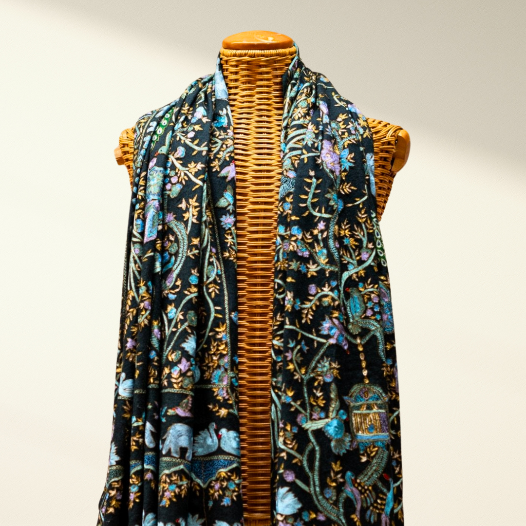 pashmina scarf with floral and animal patterns on a mannequin against a neutral background