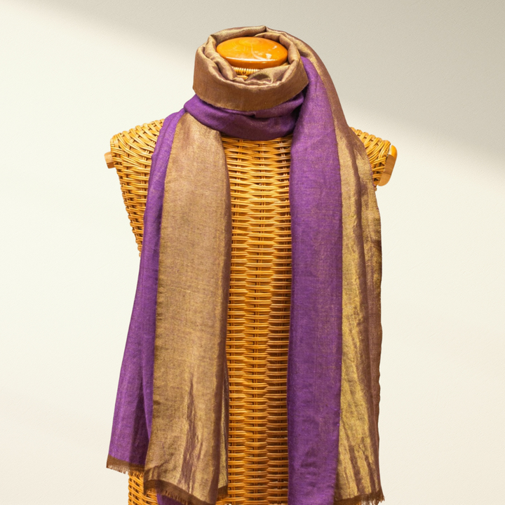 Mannequin wearing a purple and brown pashmina scarf with a neutral background