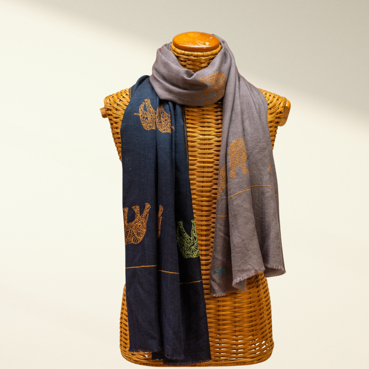 reversible scarf, navy and gray, draped over a wicker mannequin against a plain background.